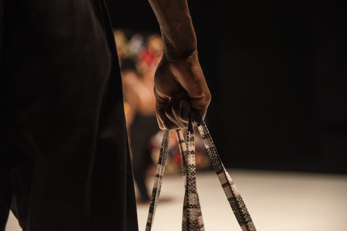 An image of a hand holding three rods.